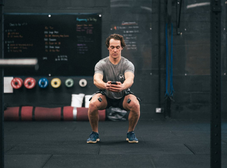 man squatting compex on quads