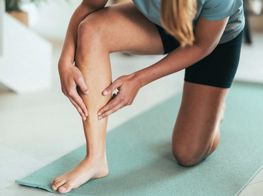 A woman holding her leg in discomfort due to a stress fracture