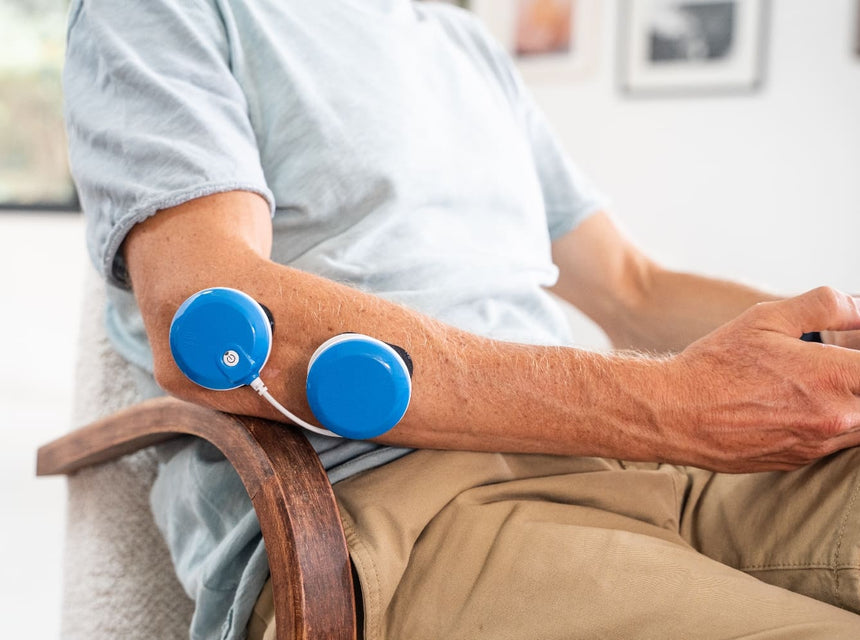 A man treating his Tennis Elbow with FIT 5.0