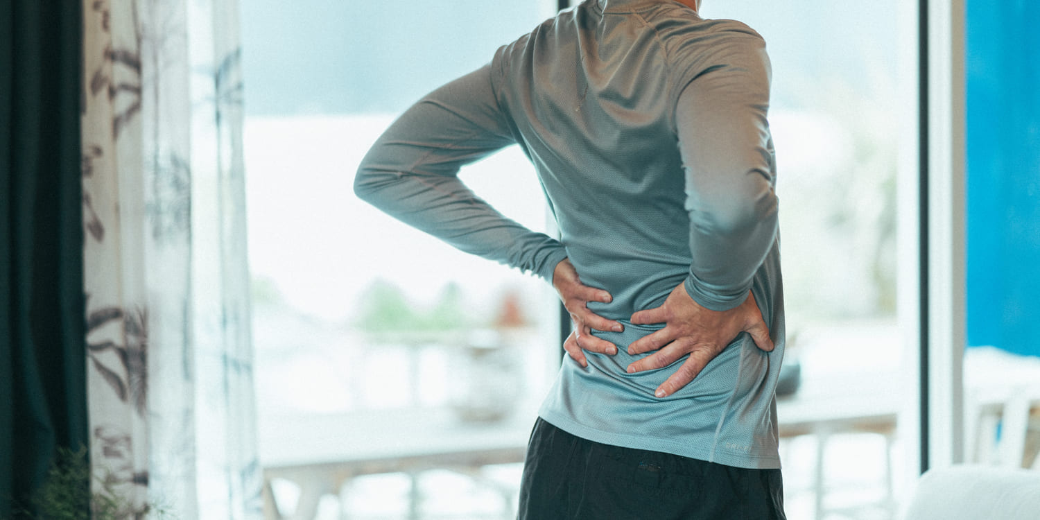 A man holding his back due to pain