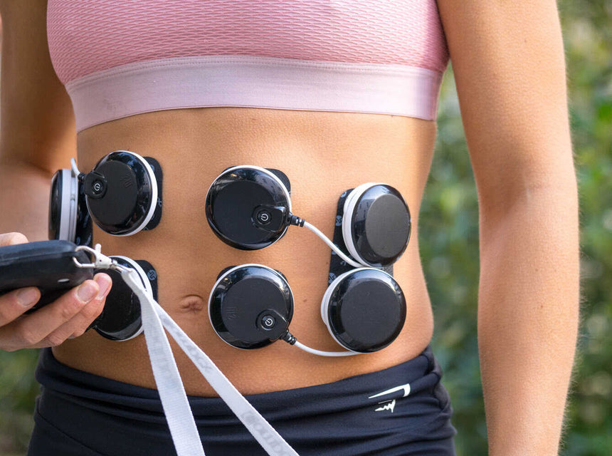 A woman exercising her glutes using the Compex FIT 5.0 muscle stimulator