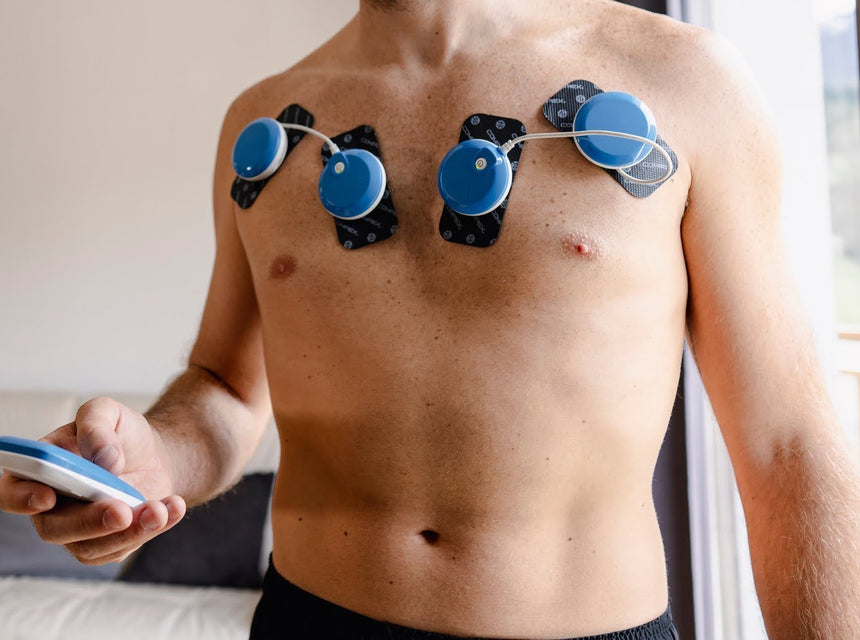 A man developing his pecs using the Compex FIT 5.0