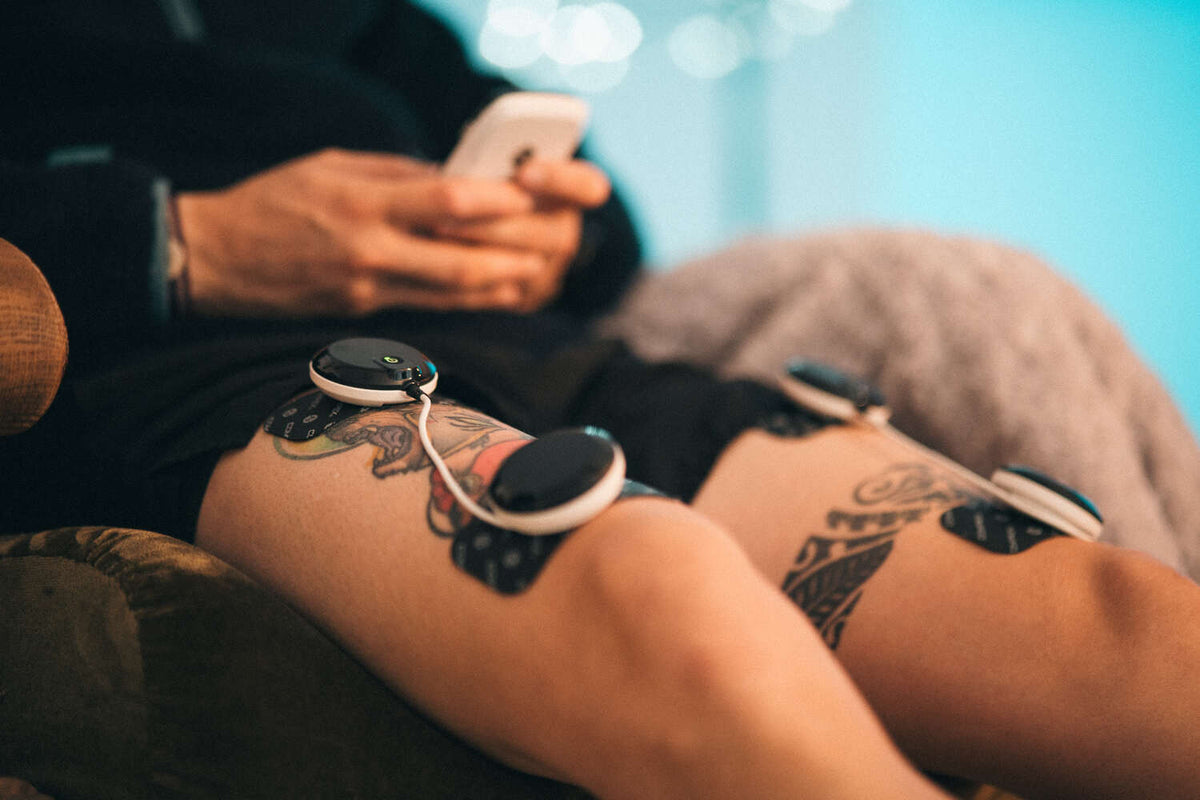 A man treating his DOMS using Compex muscle stimulation