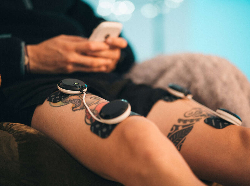 A man treating his DOMS using Compex muscle stimulation