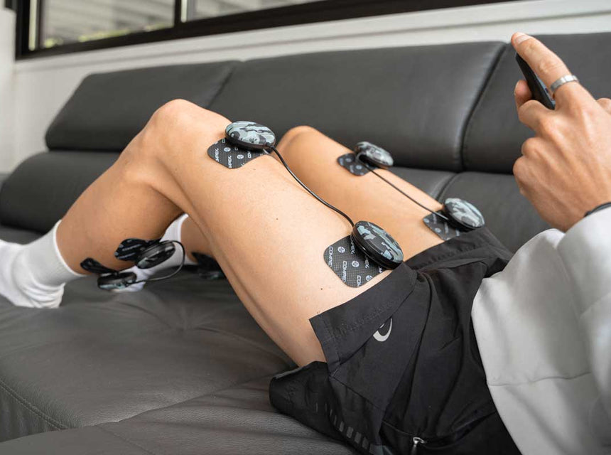 Une femme qui réaliser une séance de gainage avec l'électrostimulation compex