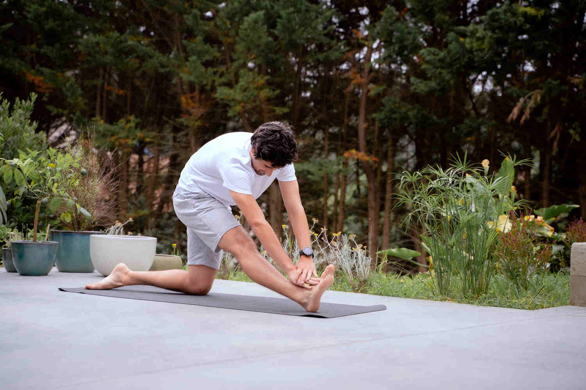 A man stretching his legs after intense anaerobic exercise