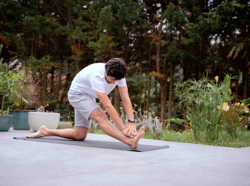 A man stretching his legs after intense anaerobic exercise