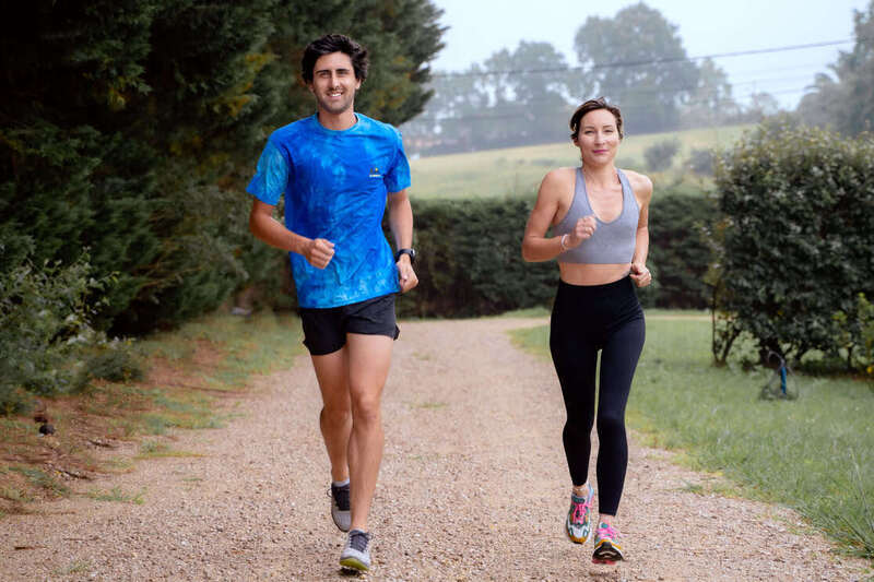 A man and a woman running together in the countryside