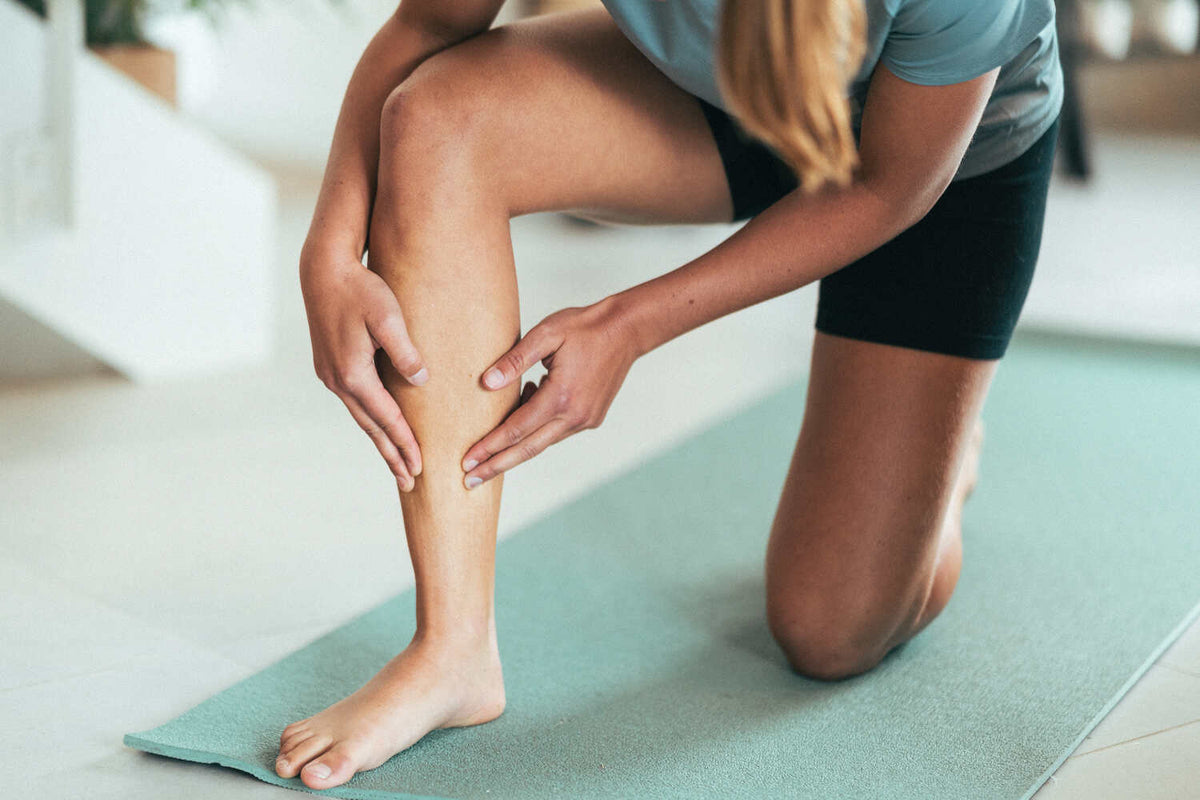 A woman holding her leg in discomfort due to a stress fracture