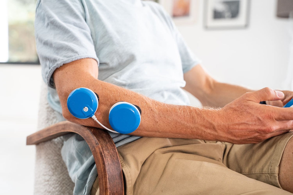 A man treating his Tennis Elbow with FIT 5.0