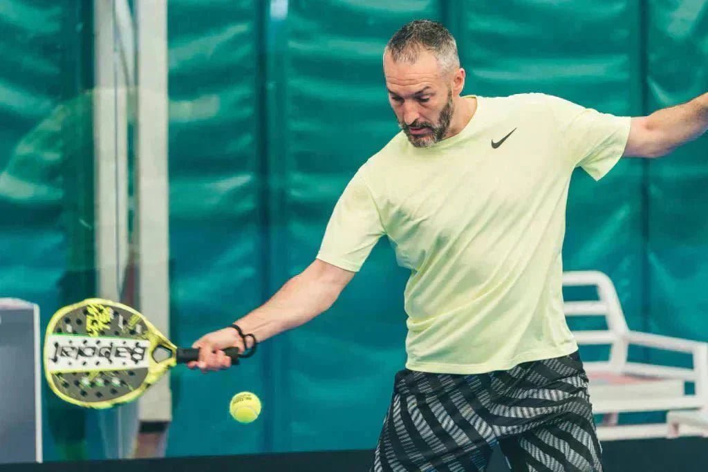 a guy plaing padel tennis