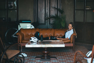 A woman adjusting the intensity on her Compex Ayre™ wireless compression boots