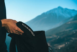 A man pulling a Compex bag out of a rucksack