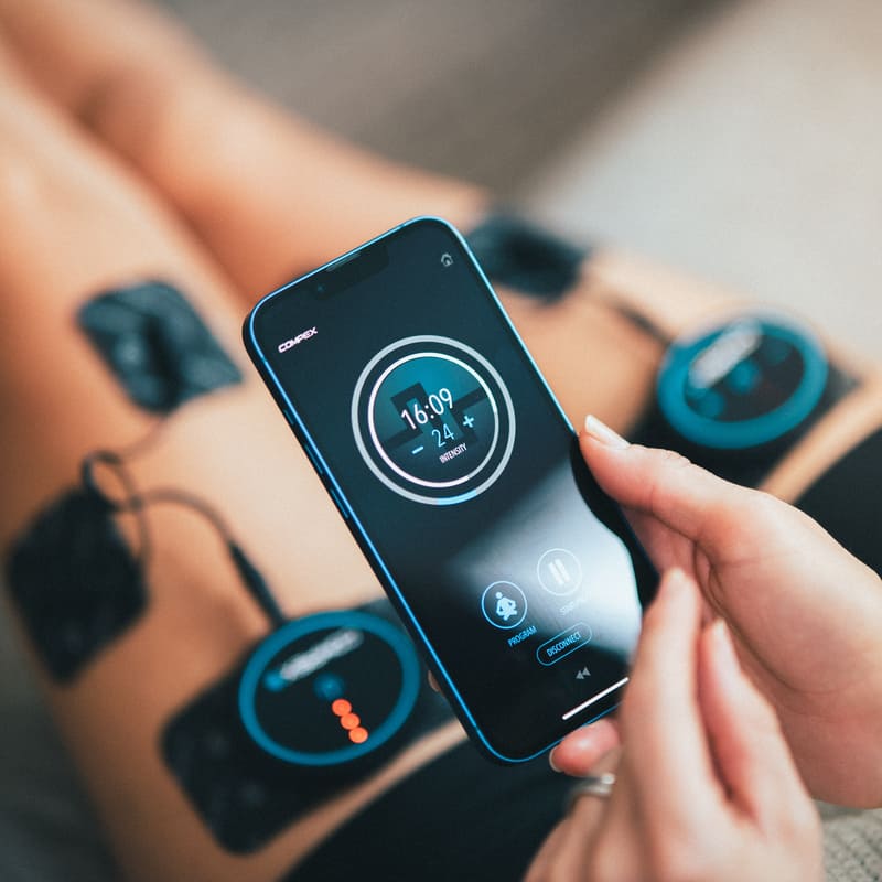 A woman using the Compex Mini App