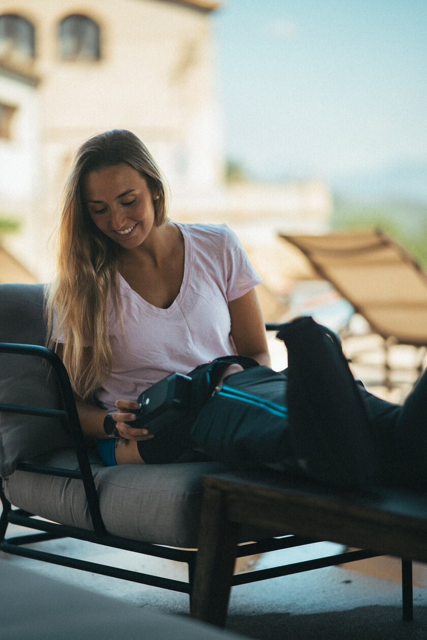 A woman setting up the Compex Ayre wireless compression boots