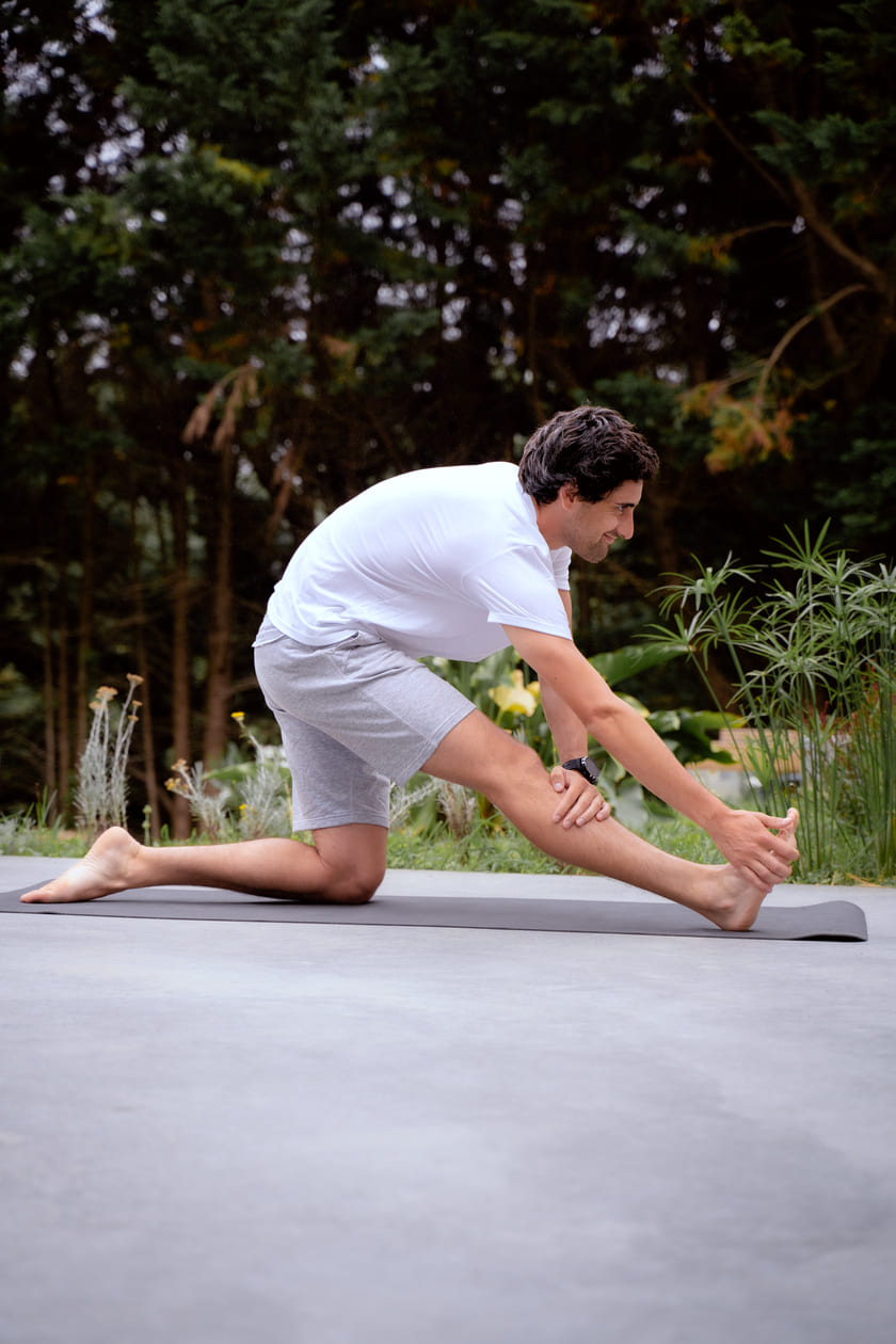 A man stretching his hamstring outside