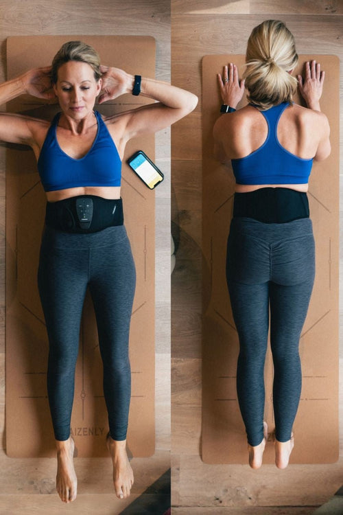 A woman doing a plank using the Compex Corebelt 1.0 EMS muscle stimulator belt