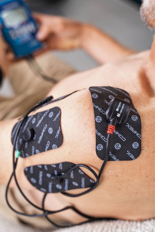 A person using the Compex Mi-Sensor on their shoulder muscles for personalised electrical muscle stimulation (EMS)