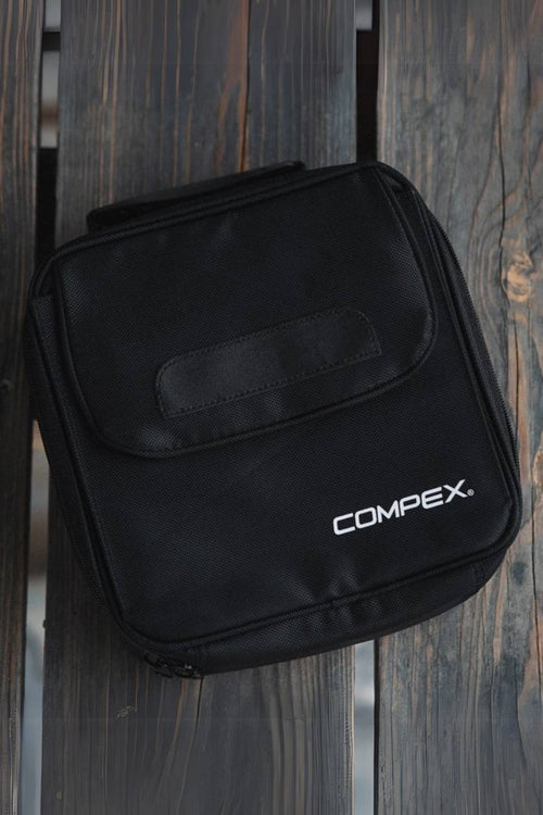 The Compex Wireless EMS Muscle Stimulator Travel Case on a wooden bench