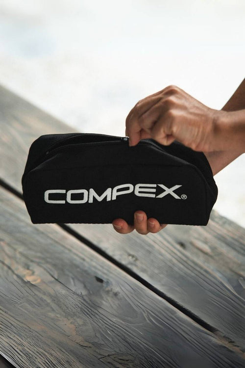 A person holding the Compex Travel Pouch for Wireless EMS Muscle Stimulators