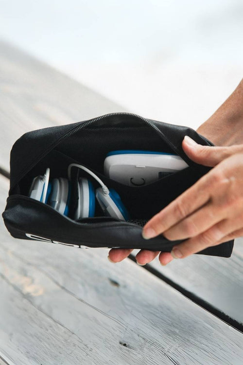 A person opening the Compex Travel Pouch for Wireless EMS Muscle Stimulators