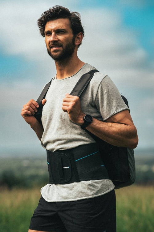 A man wearing the Compex Activ' Back Belt