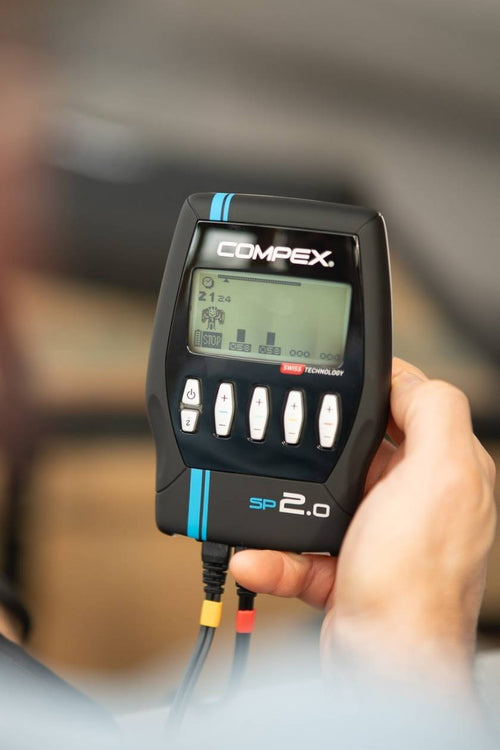 A woman doing a strengthening session using the Compex SP 2.0 EMS muscle stimulator
