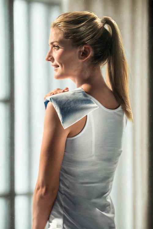 A woman using the Compex hot & cold gel pack to relieve shoulder pain