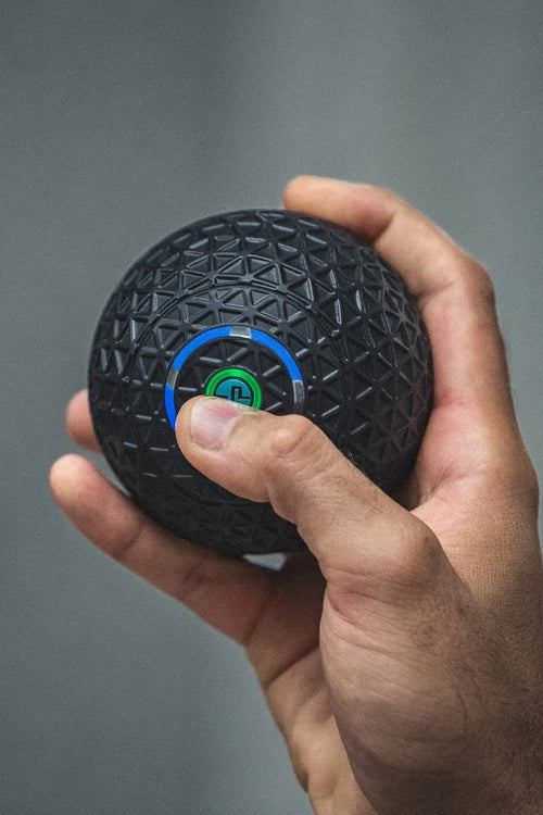 A man turning on the Compex Molecule vibrating massage ball