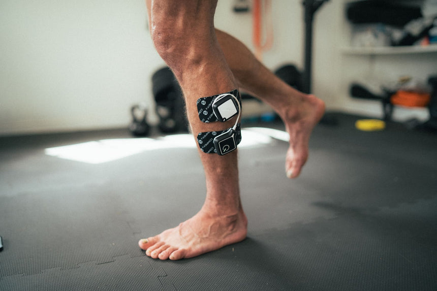 A man using the Compex Ultimate EMS device to help recondition his ankle stabilisation muscles