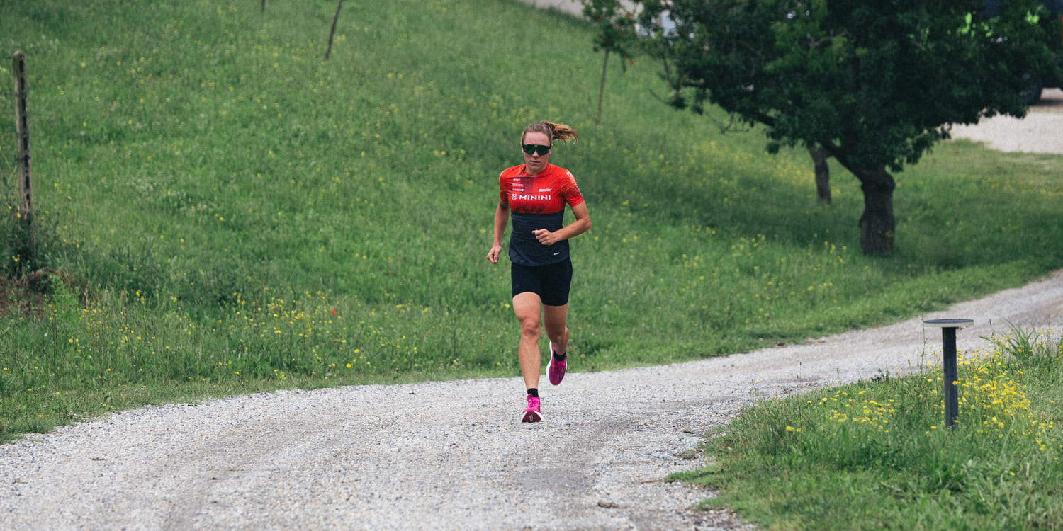 A woman running down a gravel track