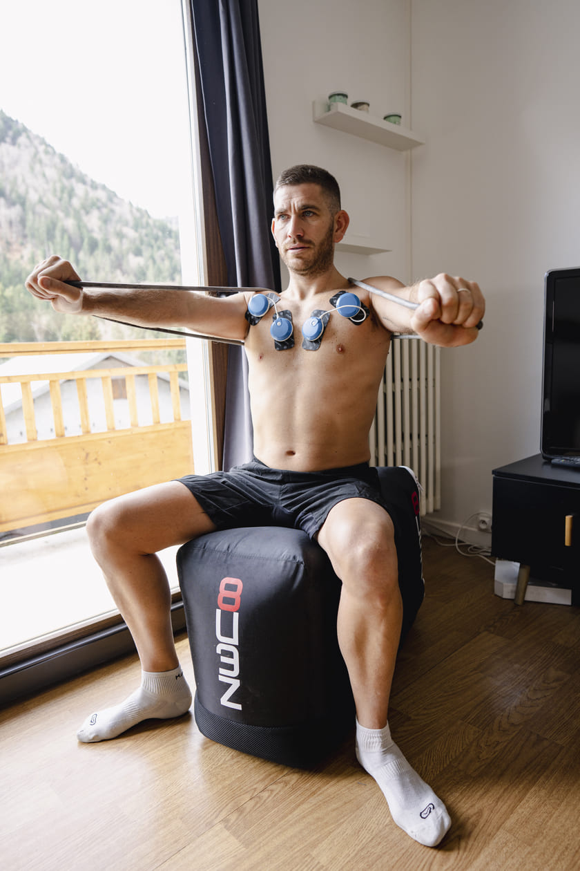 A man improving his pecs using the Compex FIT 5.0 EMS muscle stimulator