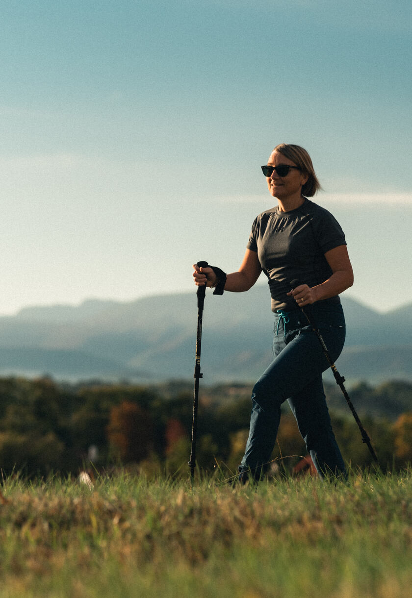 A woman hiking in a field