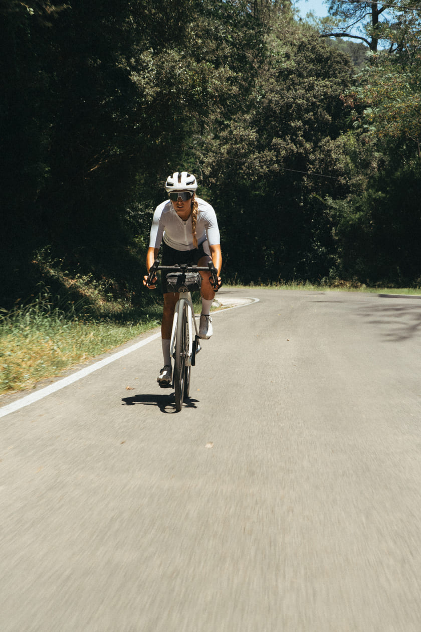 A woman cycling on a road