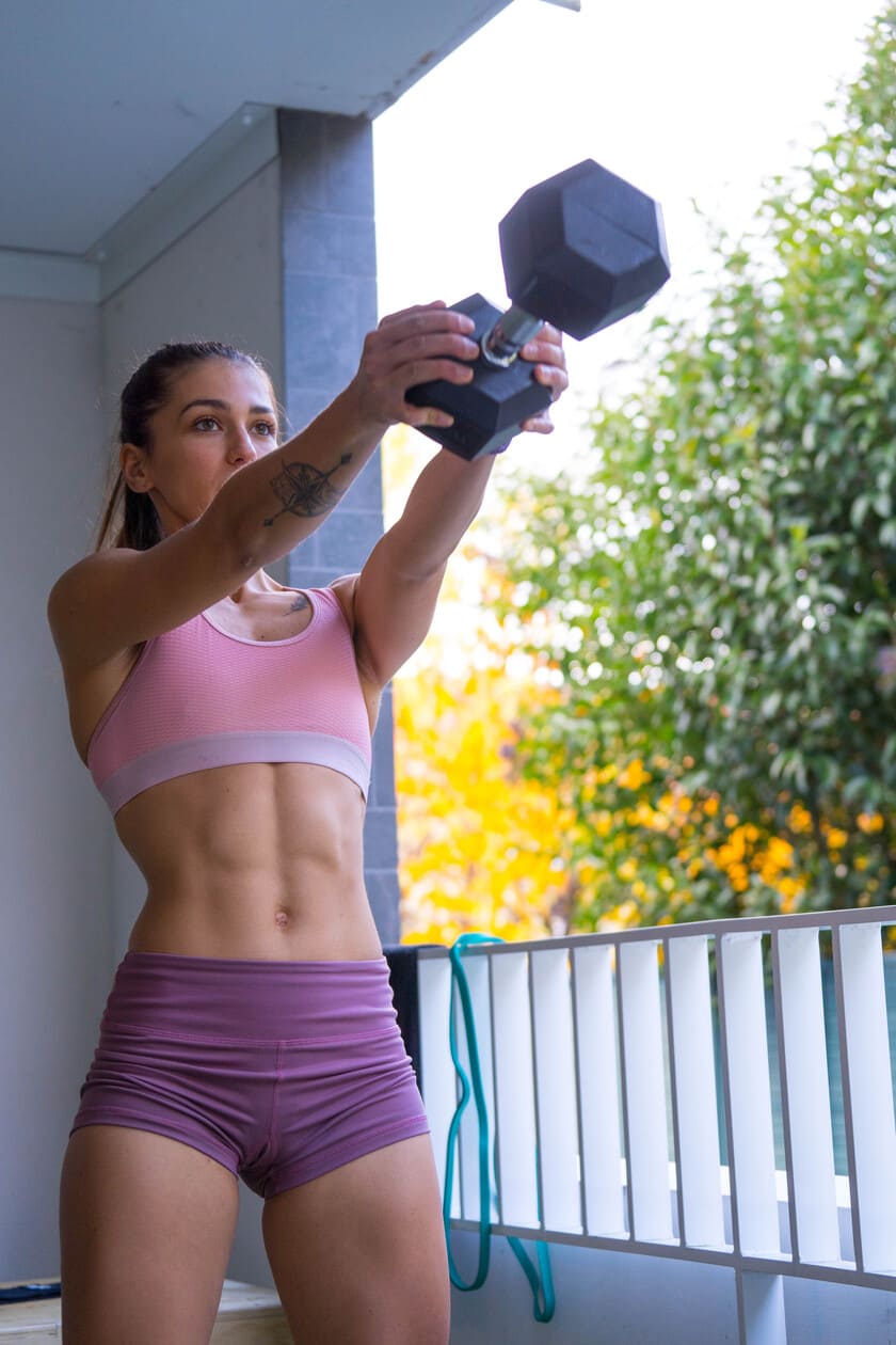 A woman doing dumbbell swings