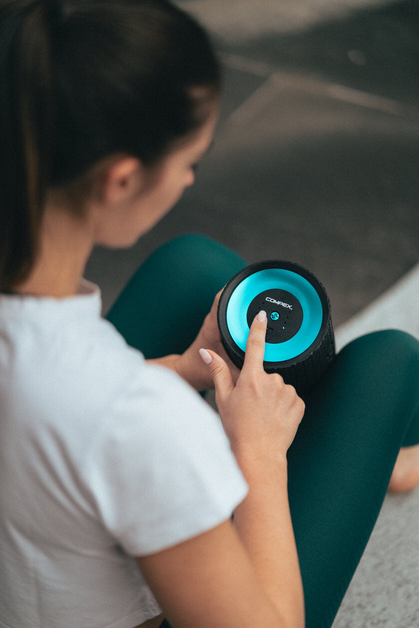A woman turning on the Compex Ion