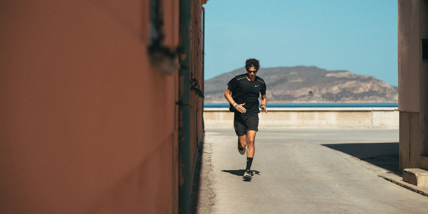Person running on a path with a scenic background