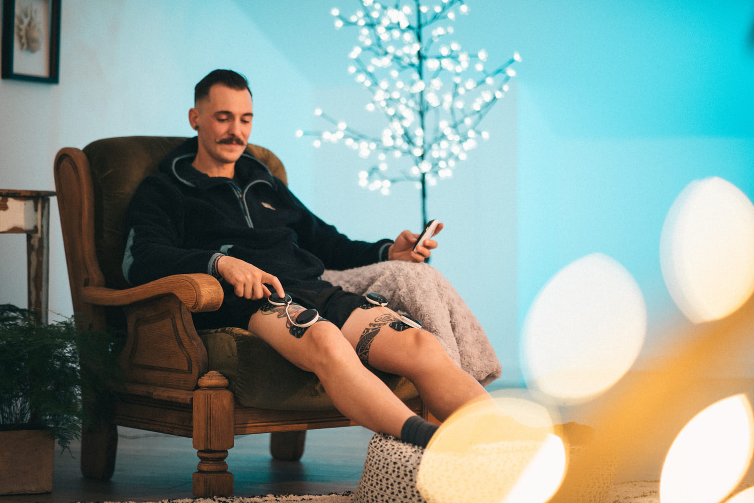 A man enjoying some recovery with the Compex SP 8.0 EMS muscle stimulator