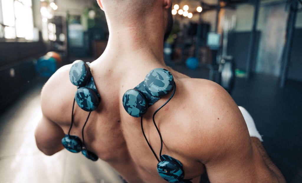 Man wearing a Compex SP 8.0 WOD Edition muscle stimulator to boost muscle performance