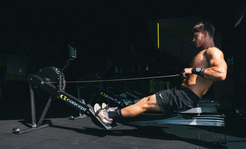 Man rowing on a Concept2 rowing machine to boost performance