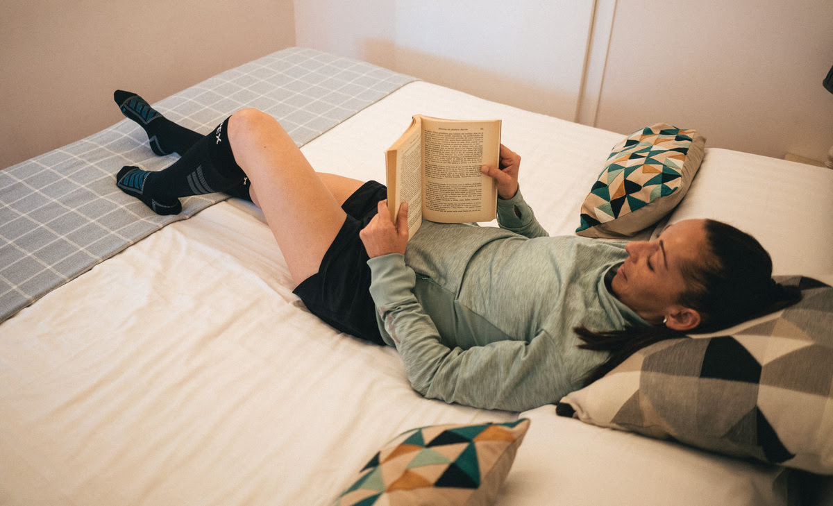 A woman laying in bed reading
