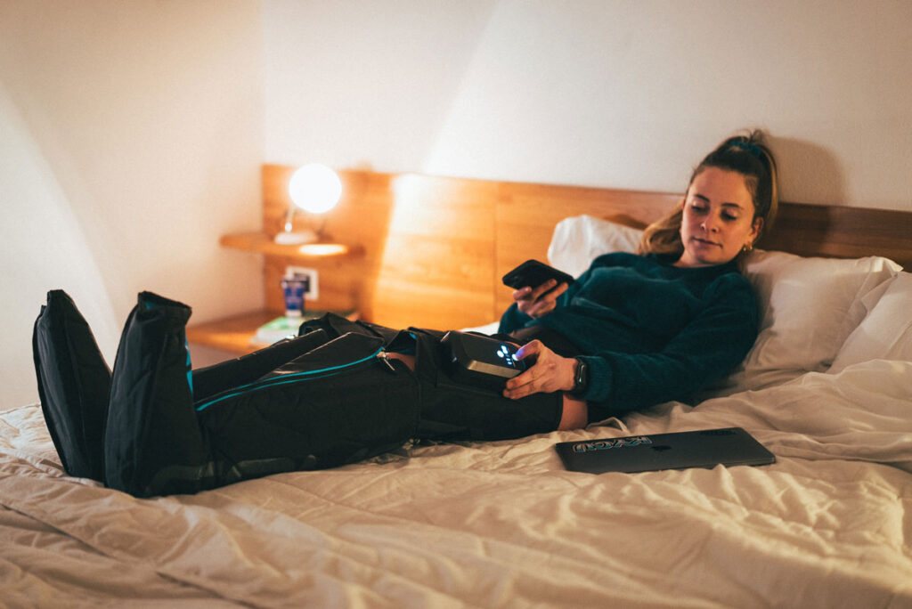 A woman practicing her recovery with Compex Ayre compression boots