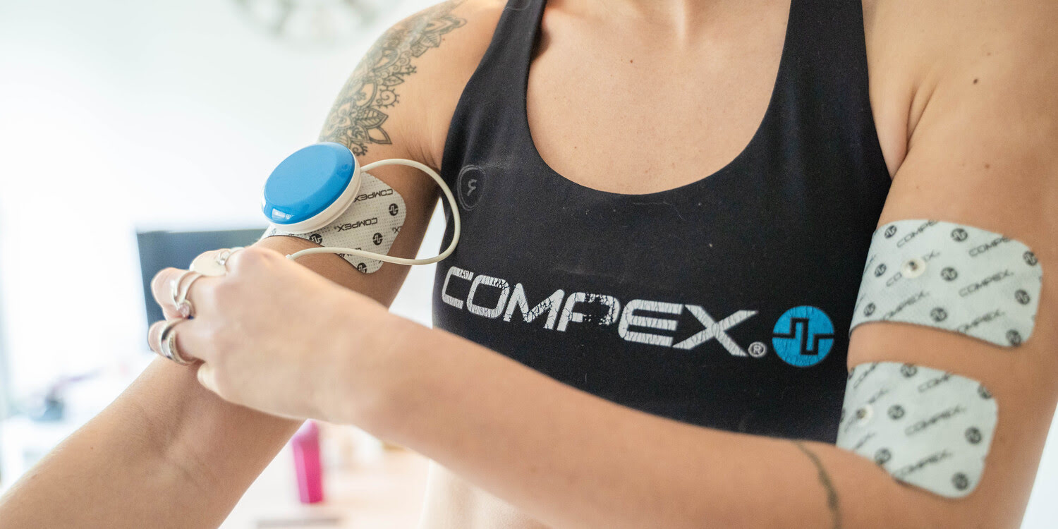 Tone your arms using the Compex FIT 5.0 muscle stimulator