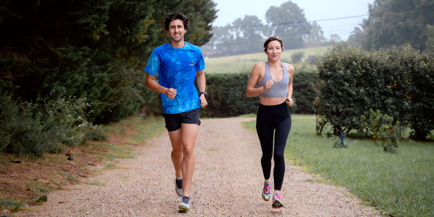 A man and a woman running in the countryside