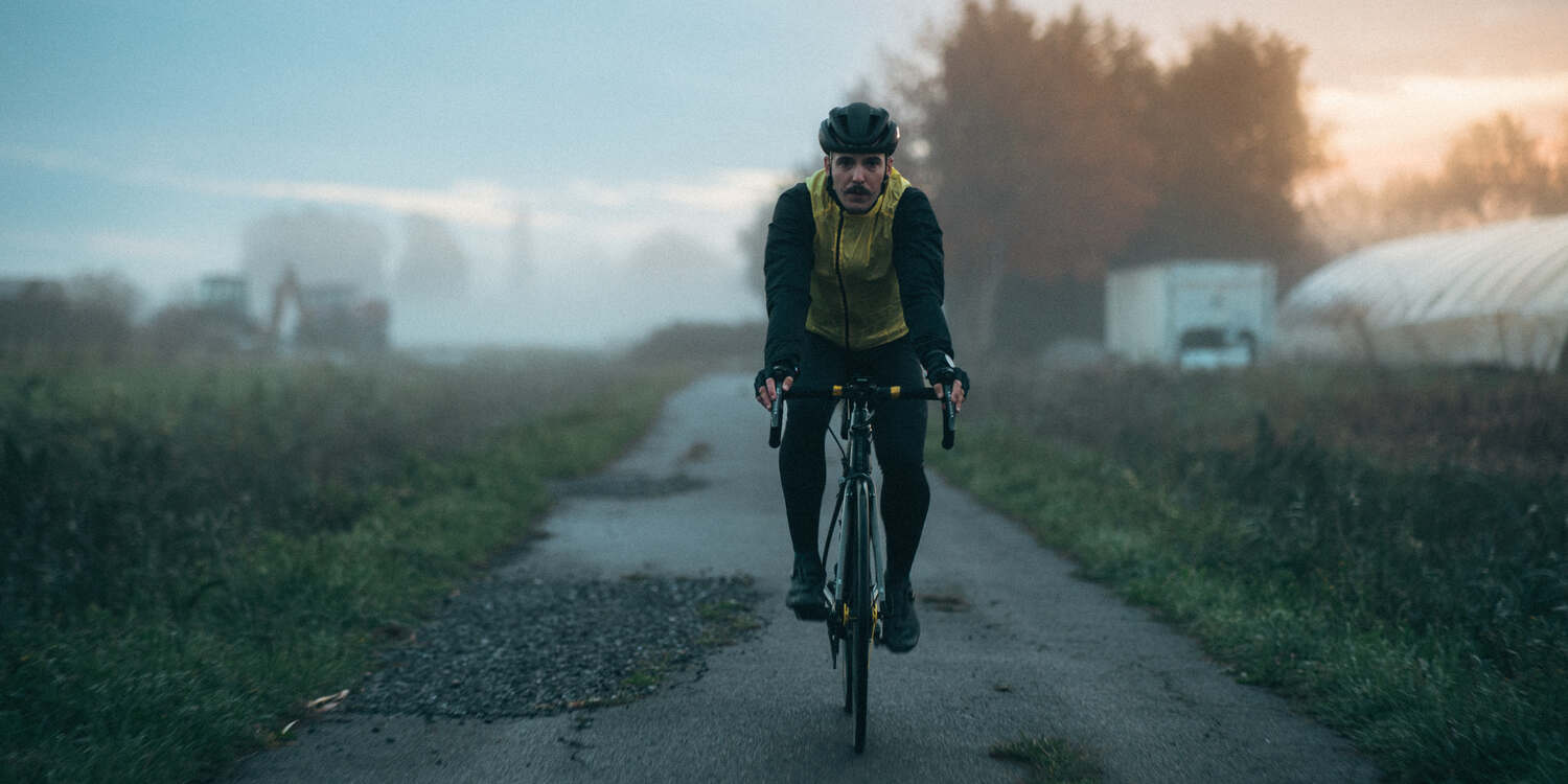 A man cycling on a road