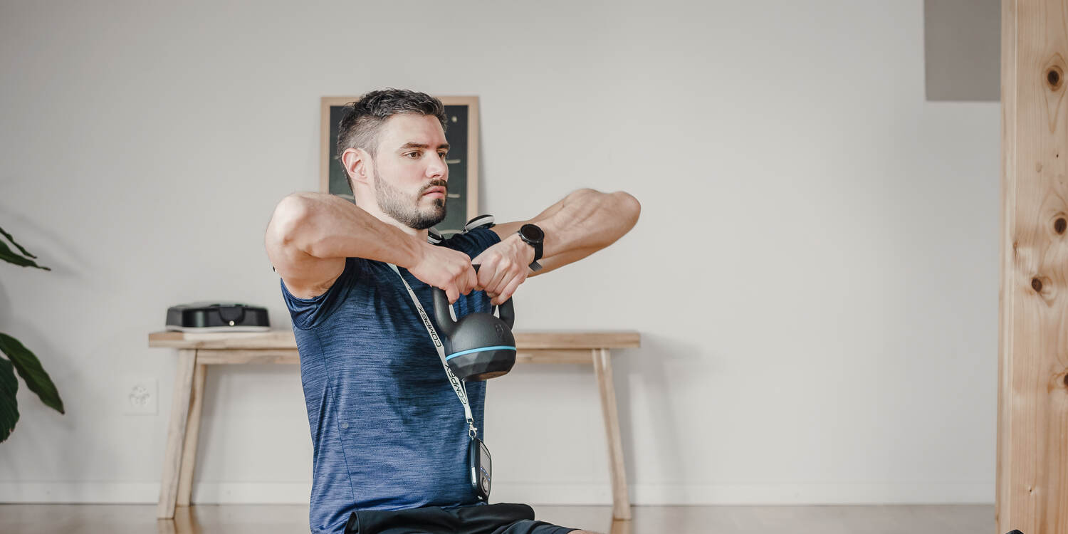 A man exercising using a Compex electrostimulator