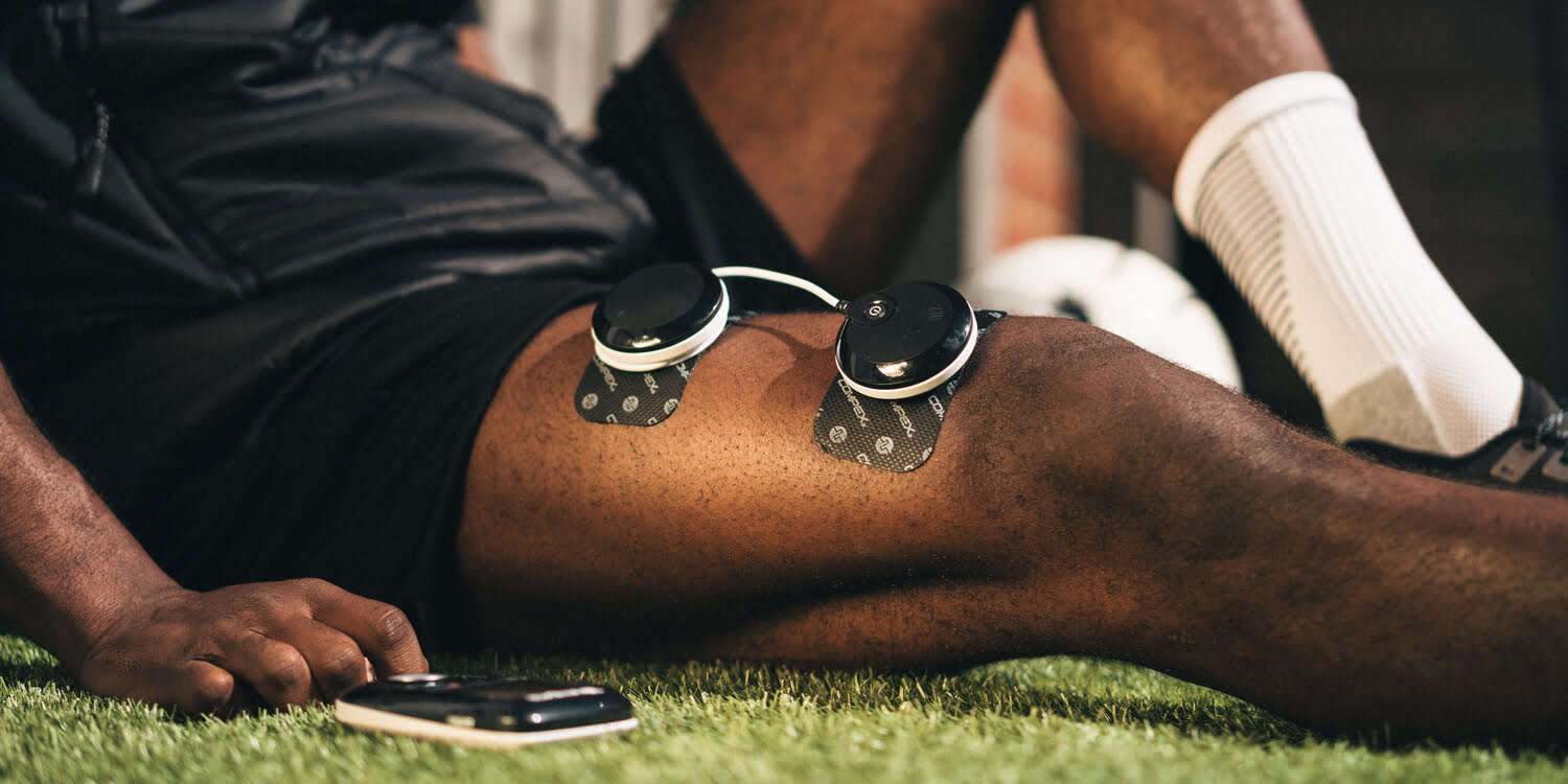 A man sitting down with the Compex SP 8.0 on his quads