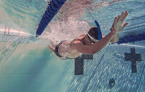 Swimmer pushing off the wall for momentum