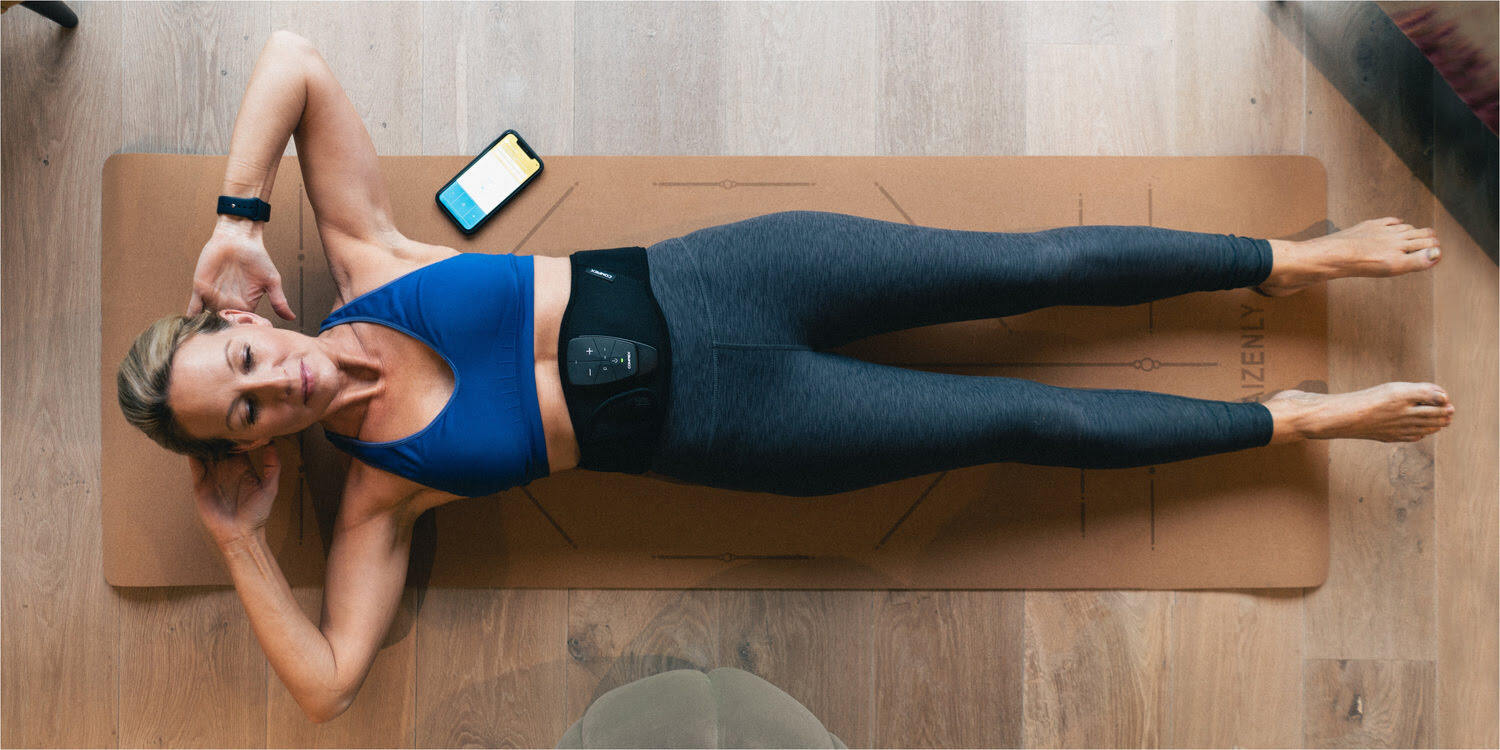 A woman getting ready to improve her abs using Compex Corebelt