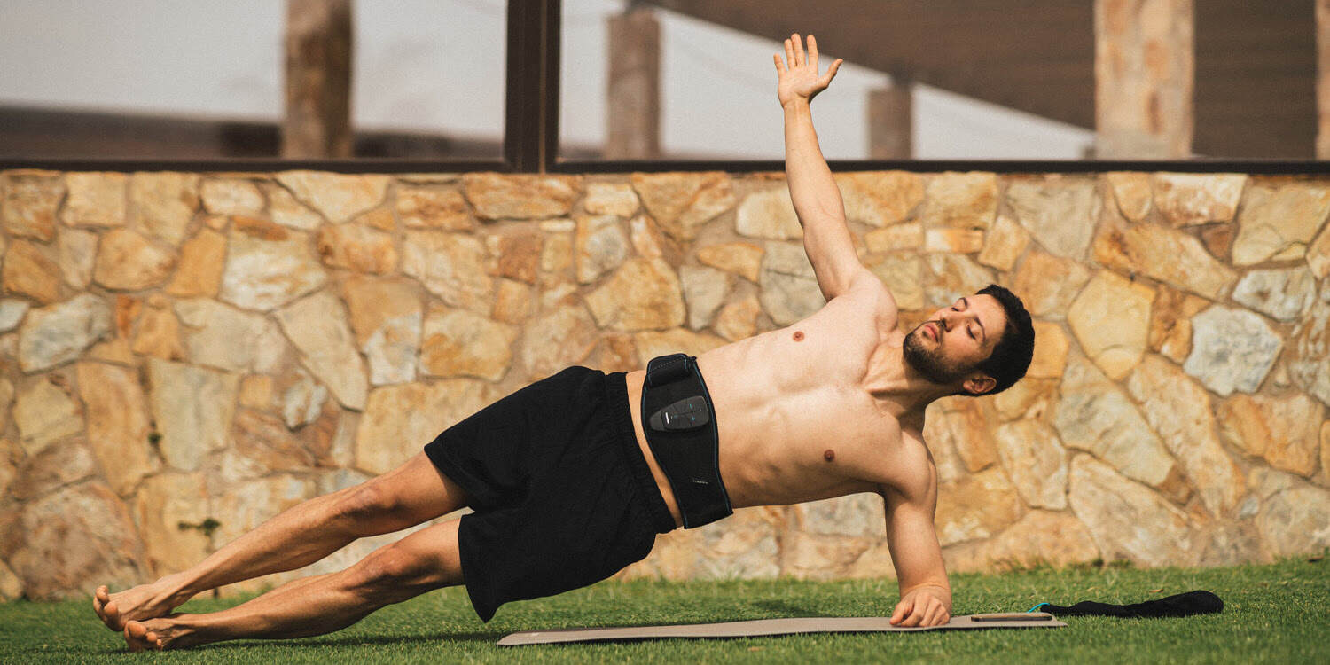 A man doing a side plank using Compex Corebelt